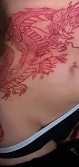 Close-up of red dragon tattoo on skin.