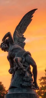 Angel statue with sunset sky in vivid orange tones for mobile wallpaper.