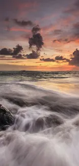 Dramatic sunset over ocean waves with an orange sky.