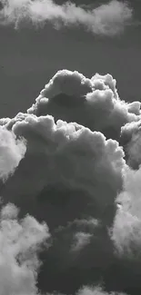 Grayscale wallpaper of dramatic cloud formations against a dark sky.