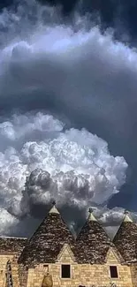 Dramatic dark blue sky with cloud formation over a stone building.