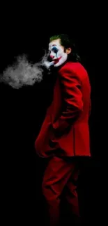 Mysterious figure in red suit with clown makeup on black background mobile wallpaper.