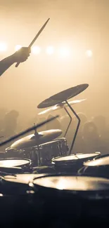 Silhouetted drummers performing with dramatic stage lighting.