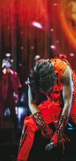 Vibrant red concert performer on stage with intense backdrop.