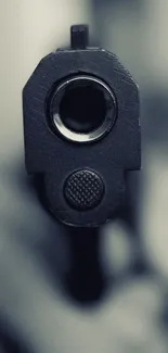 Close-up view of a gun barrel with a dramatic focus.