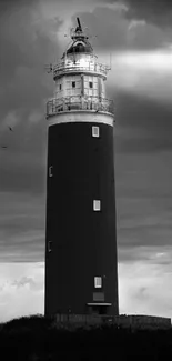 Moody lighthouse under dramatic sky mobile wallpaper.