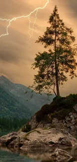 A lone tree on a rock with lightning in a dramatic mountain landscape.