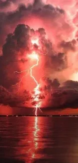 Dramatic red lightning strikes through dark clouds over water.