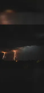 Vivid lightning strikes illuminate the night sky over a dark landscape.