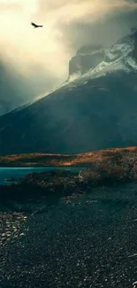 A dramatic mountain landscape with moody skies and rugged peaks.