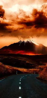 Dramatic mountain landscape at sunset with vibrant orange clouds.