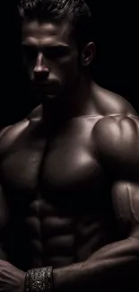 Dramatic portrait of a muscular man with a dark background.