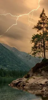 Lightning strikes over a mountain lake with a lone tree, creating a dramatic scene.