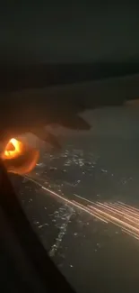 Airplane with fiery sparks at night over city lights.