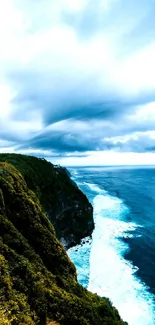 Vibrant ocean cliff view with blue sea and green landscape.