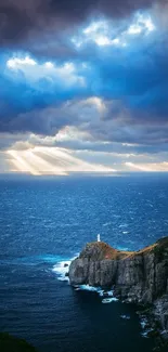 Dramatic coastal landscape with lighthouse under stormy sky.