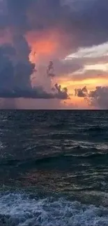 A dramatic ocean sunset with vibrant sky and dark sea.