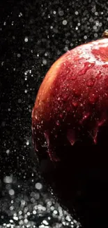 Dramatic red apple with water droplets against a dark background.