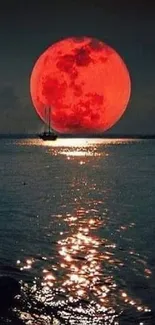 Red moon over a tranquil ocean with silhouetted sailboat.