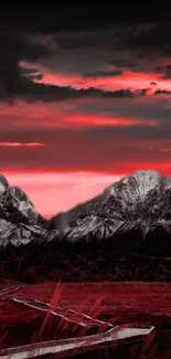 Red sunset over snowy mountains with dramatic clouds.