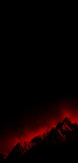 Dramatic red-lit mountain under a dark night sky.