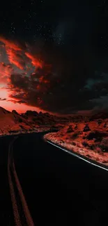 Dramatic red sky over a scenic road at night with striking clouds.