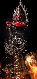 Red mythical statue with ornate details on a dark background.