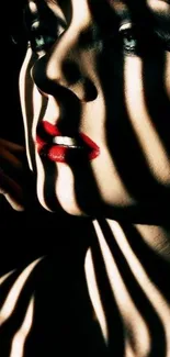 Dramatic portrait with shadows and bold red lips on a dark wallpaper.