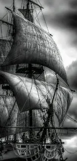 Vintage sailing ship against stormy gray skies.