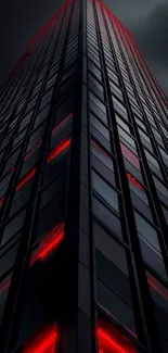 Tall skyscraper with red illuminated windows against a dark sky.
