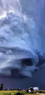 Dramatic storm cloud forming over landscape with vivid sky.