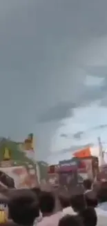 Stormy sky looms over a crowded street.