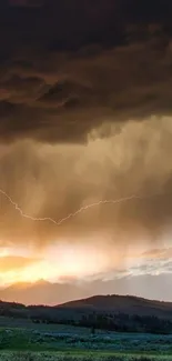 Stormy sky with lightning over hills during sunset.