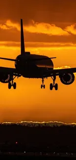 Silhouette of airplane during sunset with orange sky backdrop.