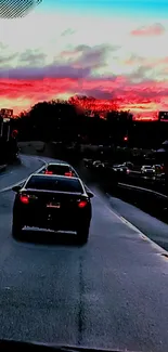 Vibrant red sunset viewed from a highway drive.