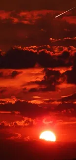 Dramatic sunset sky with vivid red clouds and a glowing sun.