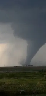 Dramatic tornado storm against a dark sky.