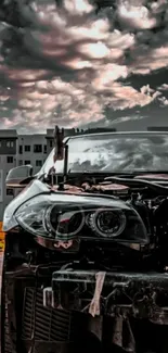 Moody car with cloudy sky in urban setting.