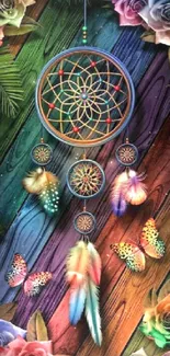 Colorful dreamcatcher with roses and butterflies on wood background.