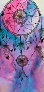 Dreamcatcher with watercolor background in pink and blue hues.