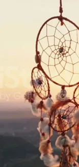 Dreamcatcher hanging in soft sunset glow with warm hues.