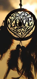 Dreamcatcher silhouetted against warm sunset.