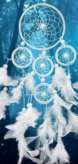 Dreamcatcher with white feathers in a mystical blue forest.