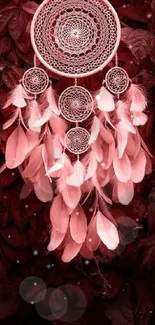 Dreamcatcher with feathers on red leafy background wallpaper.