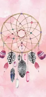 Dreamcatcher with feathers on pastel pink background wallpaper.