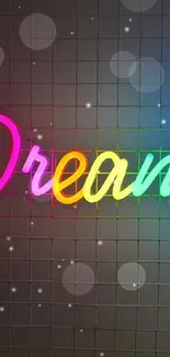 Colorful neon 'Dreamer' sign on a dark grid background.