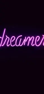 Dreamer in pink neon on black background wallpaper.