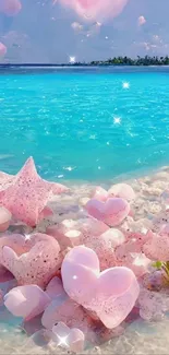 Beach scene with pink heart stones and turquoise ocean water.