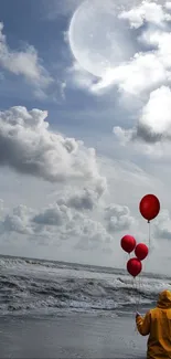 Person holding balloons on a cloudy beach.