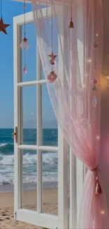 Open window with pink curtains overlooking a beach.